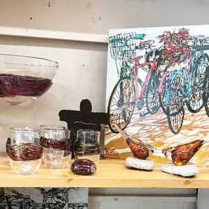 Shelf of goods: glassware, painting